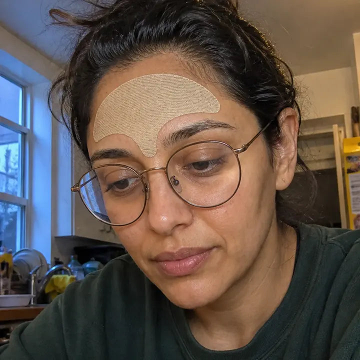 Priya, wearing the wrinkle smoothing forehead tape
