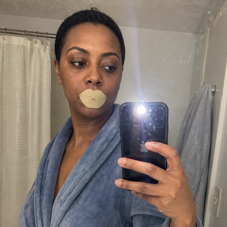 Selam, taking a mirror selfie in a robe